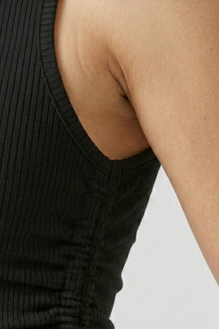Women’s crop top with side ruching, round neckline, and ribbed texture, designed for casual wear and summer outfits