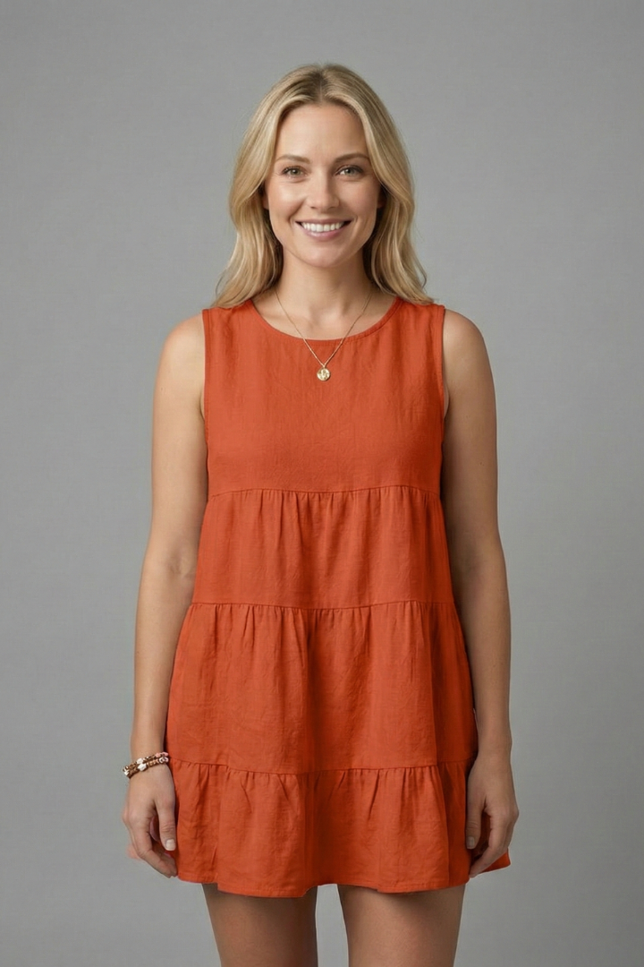 Women’s sleeveless top with round neckline and tiered hem detail, suitable for casual wear and relaxed summer outfits.