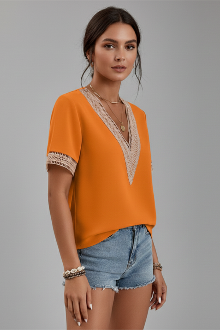 Women’s V-neck blouse with decorative trim, short sleeves, and straight fit, suitable for everyday wear and office outfits.