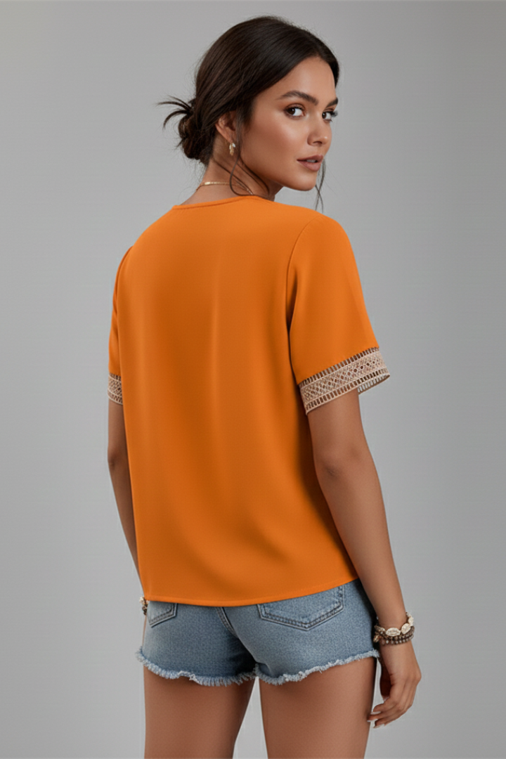 Women’s V-neck blouse with decorative trim, short sleeves, and straight fit, suitable for everyday wear and office outfits.