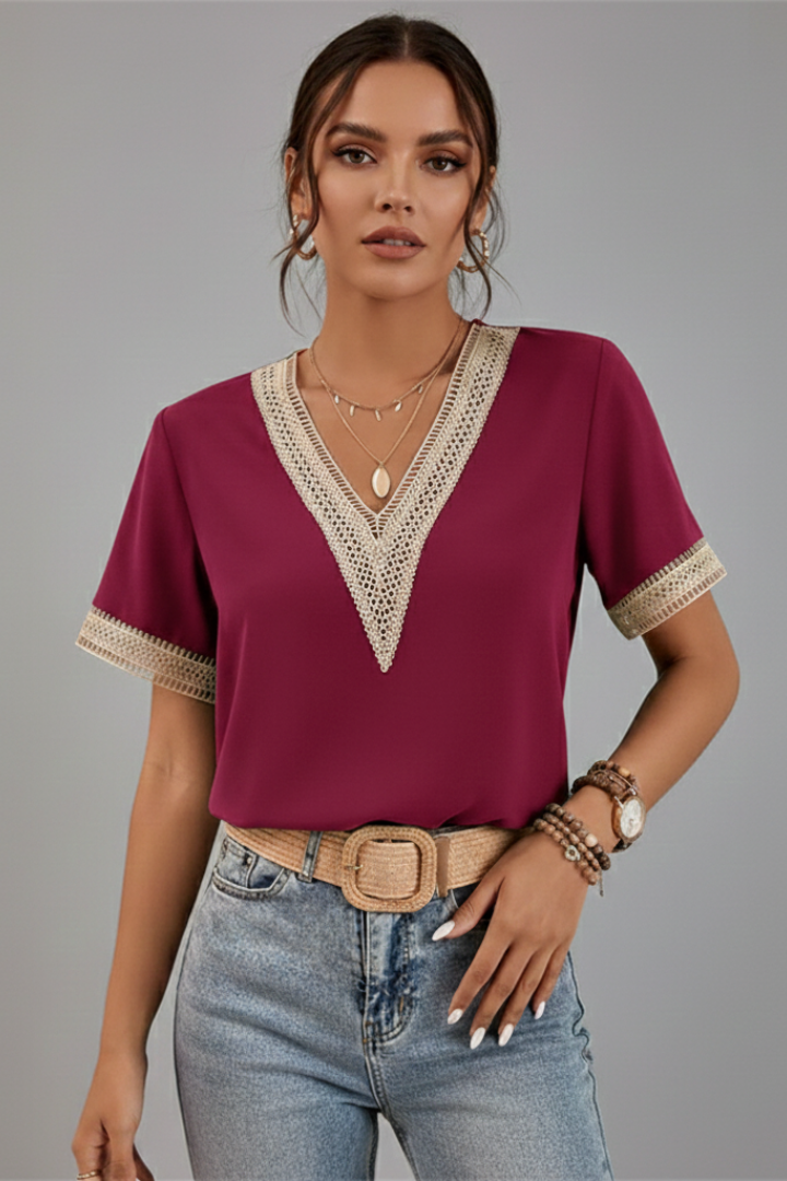 Women’s V-neck blouse with decorative trim, short sleeves, and straight fit, suitable for everyday wear and office outfits.