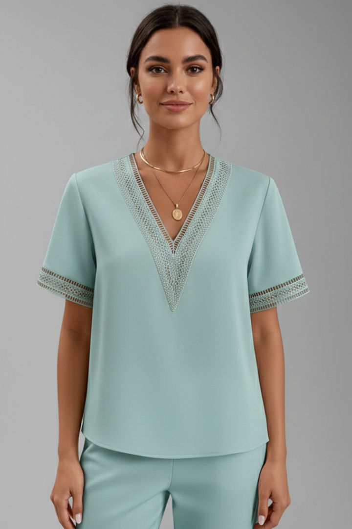 Women’s V-neck blouse with decorative trim, short sleeves, and straight fit, suitable for everyday wear and office outfits.