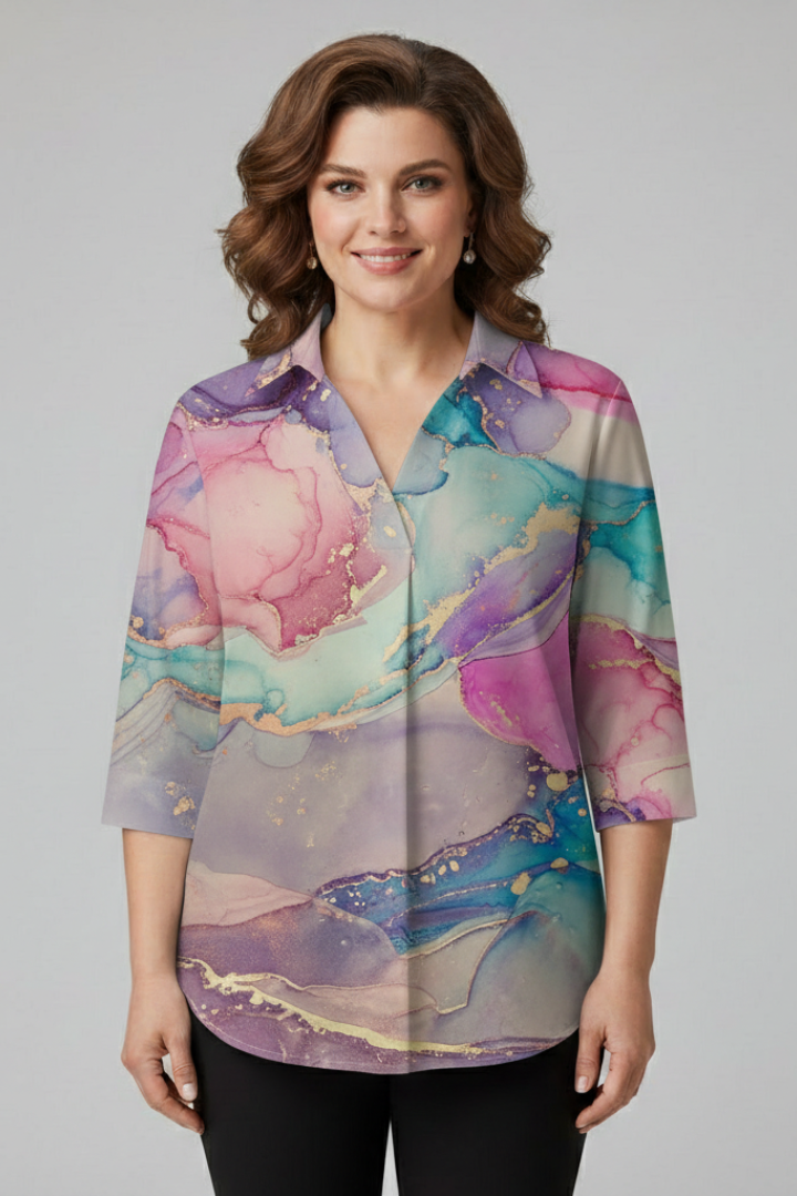 Women’s blouse with chevron stripe print and button front detail, featuring three-quarter sleeves and an asymmetrical hem for everyday styling.