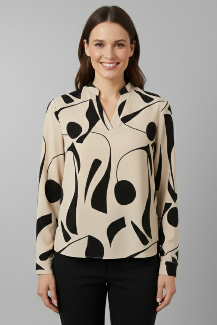 Women’s collared blouse with button front and abstract print, featuring long sleeves and a curved hem for everyday and work styling.