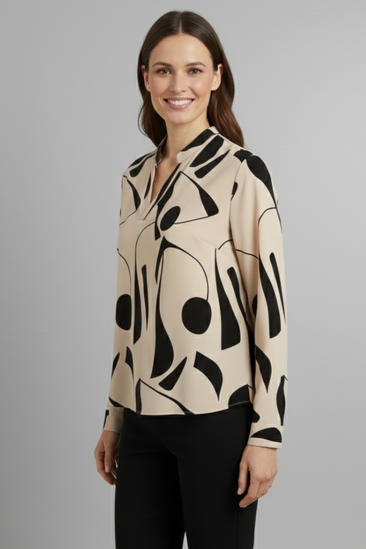 Women’s collared blouse with button front and abstract print, featuring long sleeves and a curved hem for everyday and work styling.