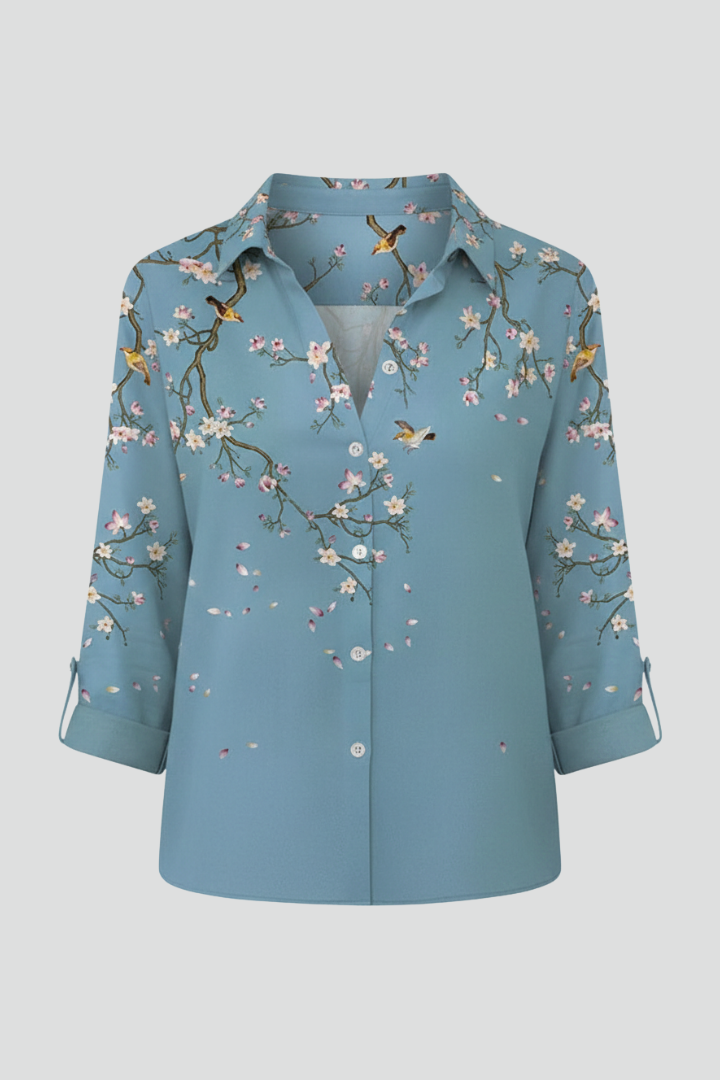Women’s blouse with collared neckline and floral print, featuring long sleeves and button closure for everyday and work styling.