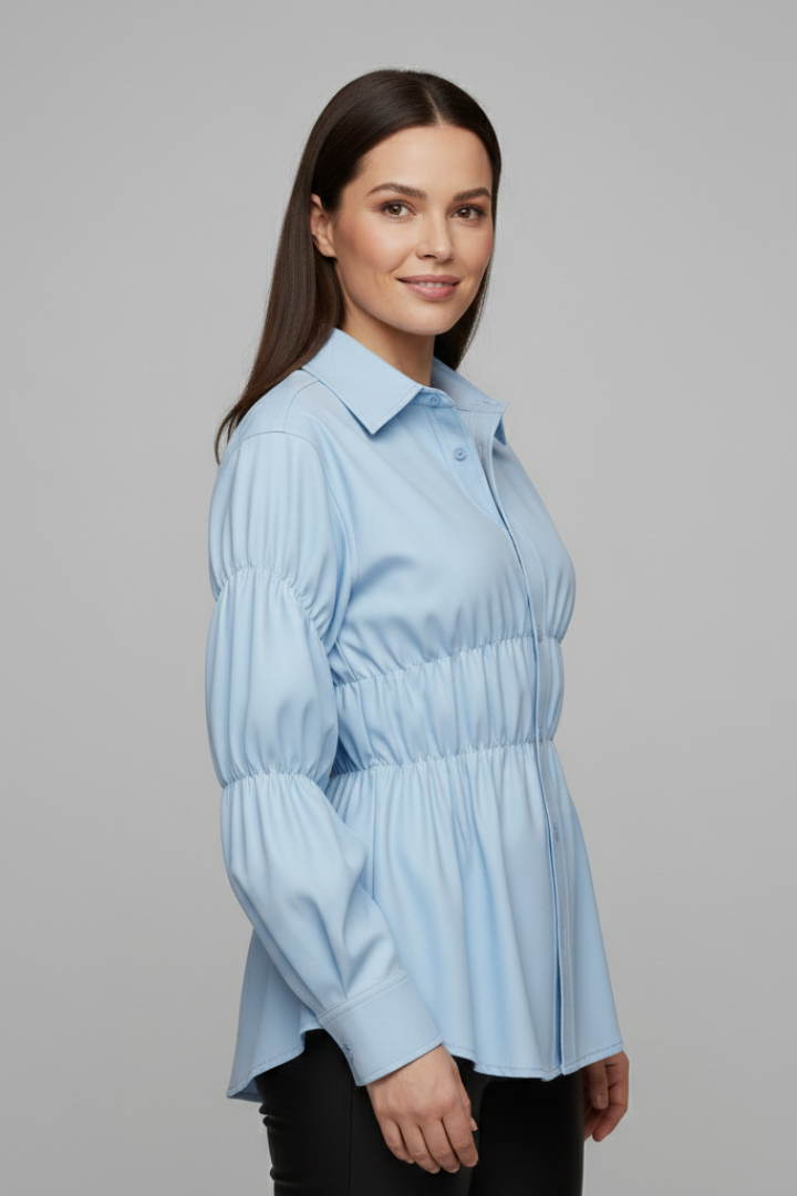 Women’s blouse with front buttons and gathered waist detail, featuring long sleeves and a flared hem for everyday and workwear styling.