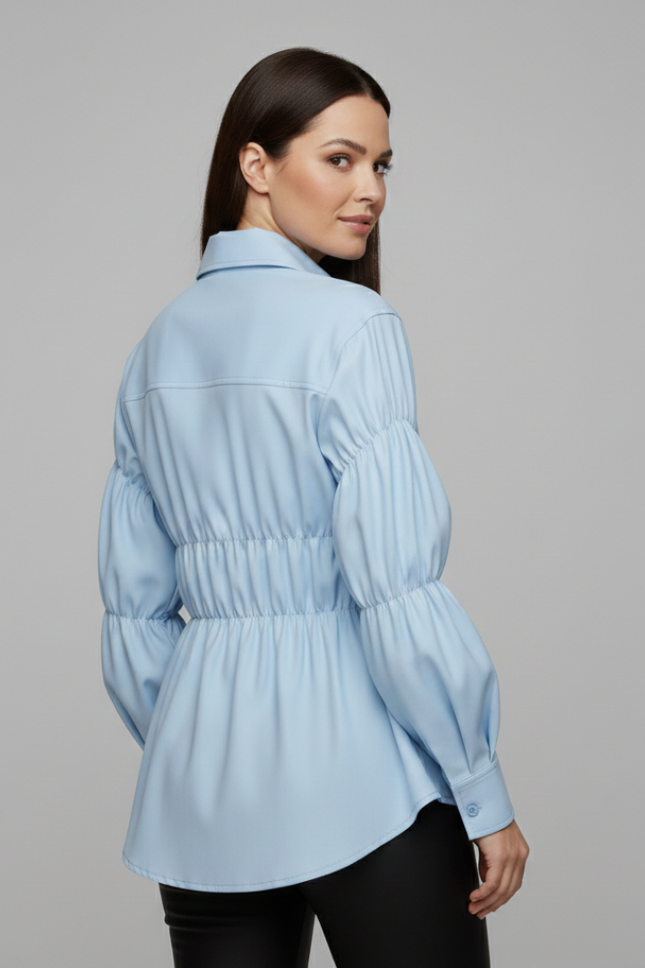 Women’s blouse with front buttons and gathered waist detail, featuring long sleeves and a flared hem for everyday and workwear styling.