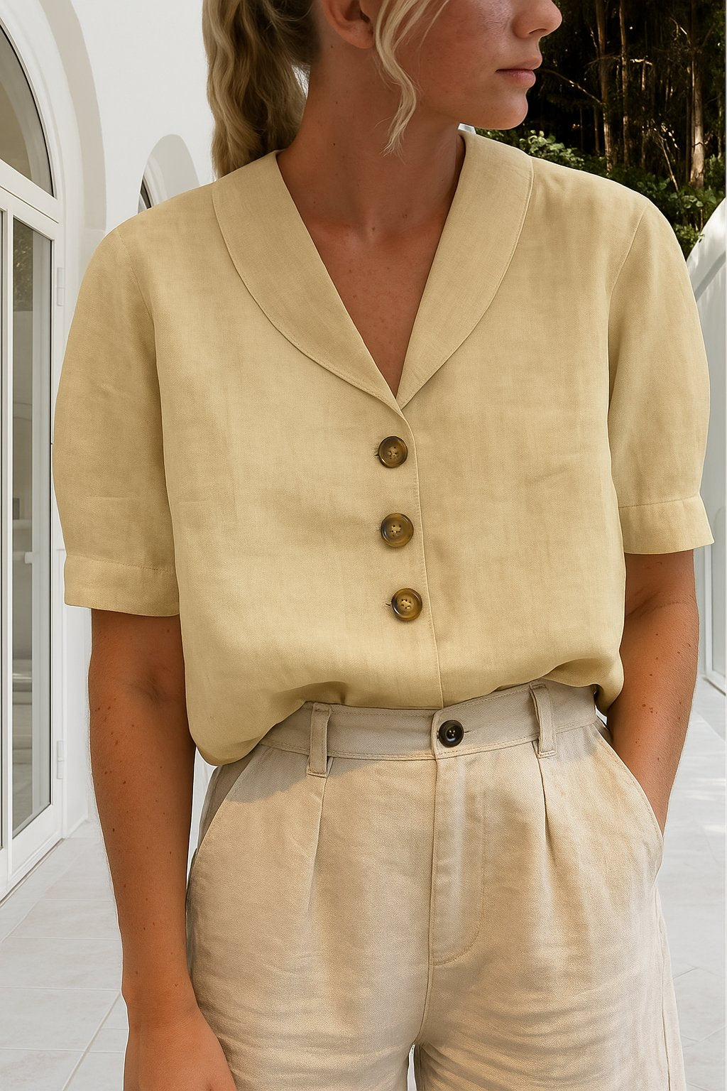 Women’s blouse with V-neckline, button-front closure, short sleeves, and relaxed fit, suitable for office wear and everyday styling.