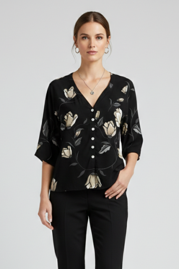 Women’s blouse with V-neckline and front button detailing, featuring short sleeves and floral print for everyday and casual styling.