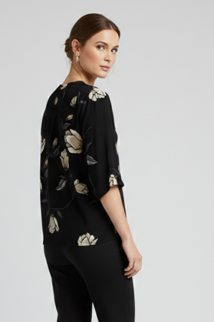 Women’s blouse with V-neckline and front button detailing, featuring short sleeves and floral print for everyday and casual styling.