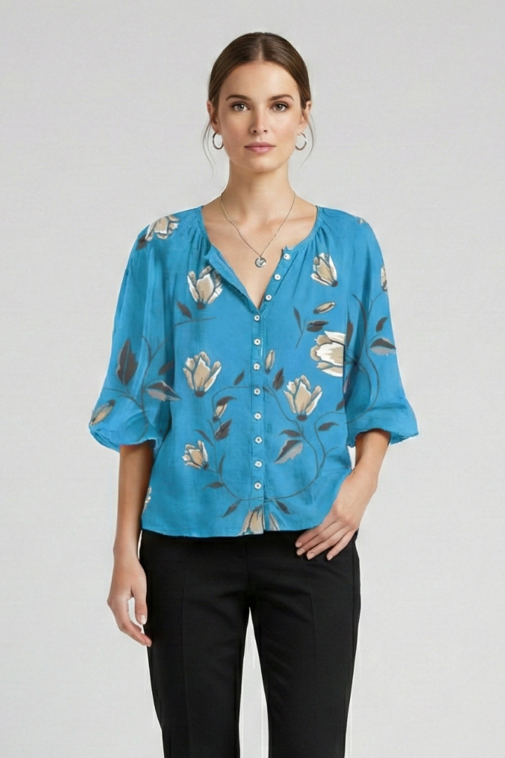 Women’s blouse with V-neckline and front button detailing, featuring short sleeves and floral print for everyday and casual styling.