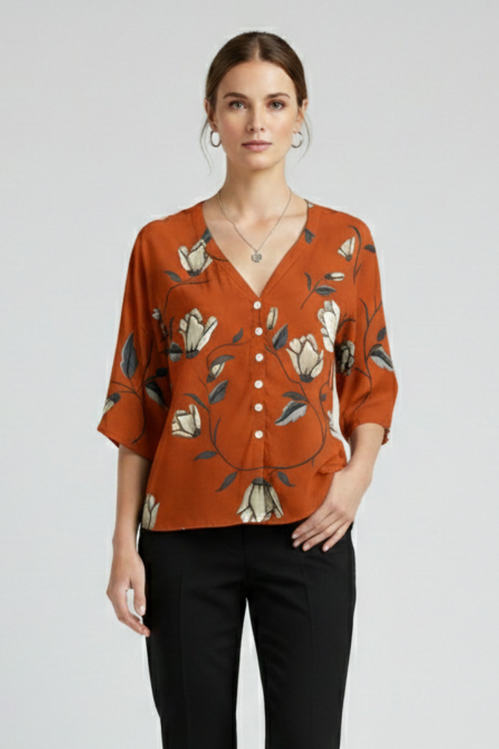Women’s blouse with V-neckline and front button detailing, featuring short sleeves and floral print for everyday and casual styling.