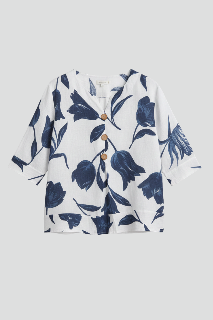 Women’s blouse with V-neckline and large floral print, featuring three-quarter sleeves and button placket for everyday and work styling.