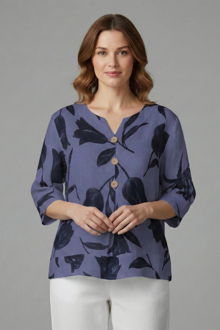 Women’s blouse with V-neckline and large floral print, featuring three-quarter sleeves and button placket for everyday and work styling.