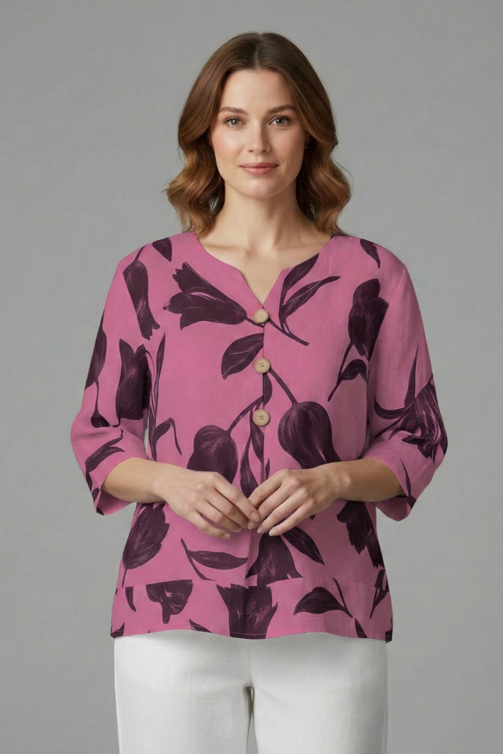 Women’s blouse with V-neckline and large floral print, featuring three-quarter sleeves and button placket for everyday and work styling.
