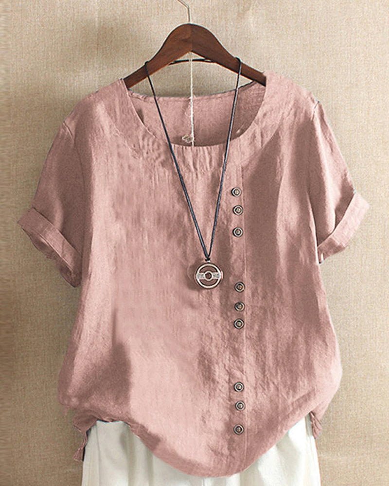 Women’s blouse with decorative button details, short sleeves, and a relaxed fit, ideal for casual summer outfits, travel, and everyday wear.