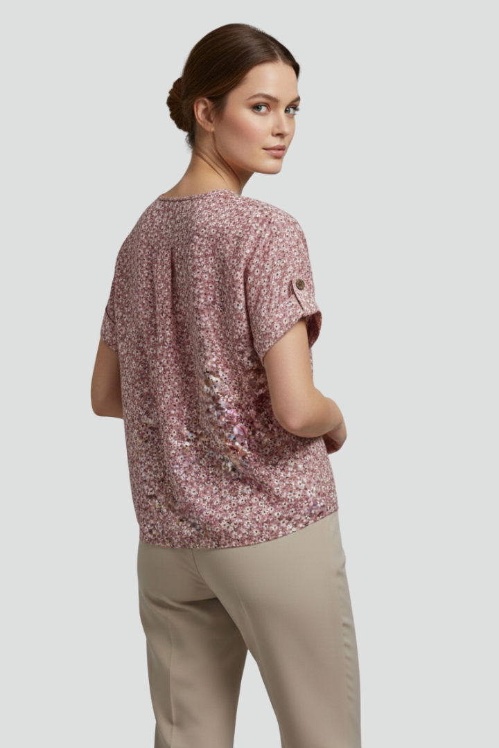 Women’s short sleeve blouse with round neckline, button front, printed surface, and straight hem for casual everyday styling.