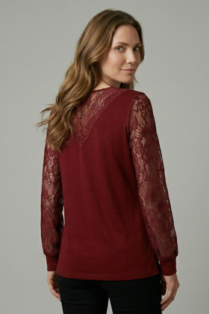 Women’s blouse with textured lace sleeves, structured V-neckline, straight hem, and smooth woven surface for elegant everyday styling.