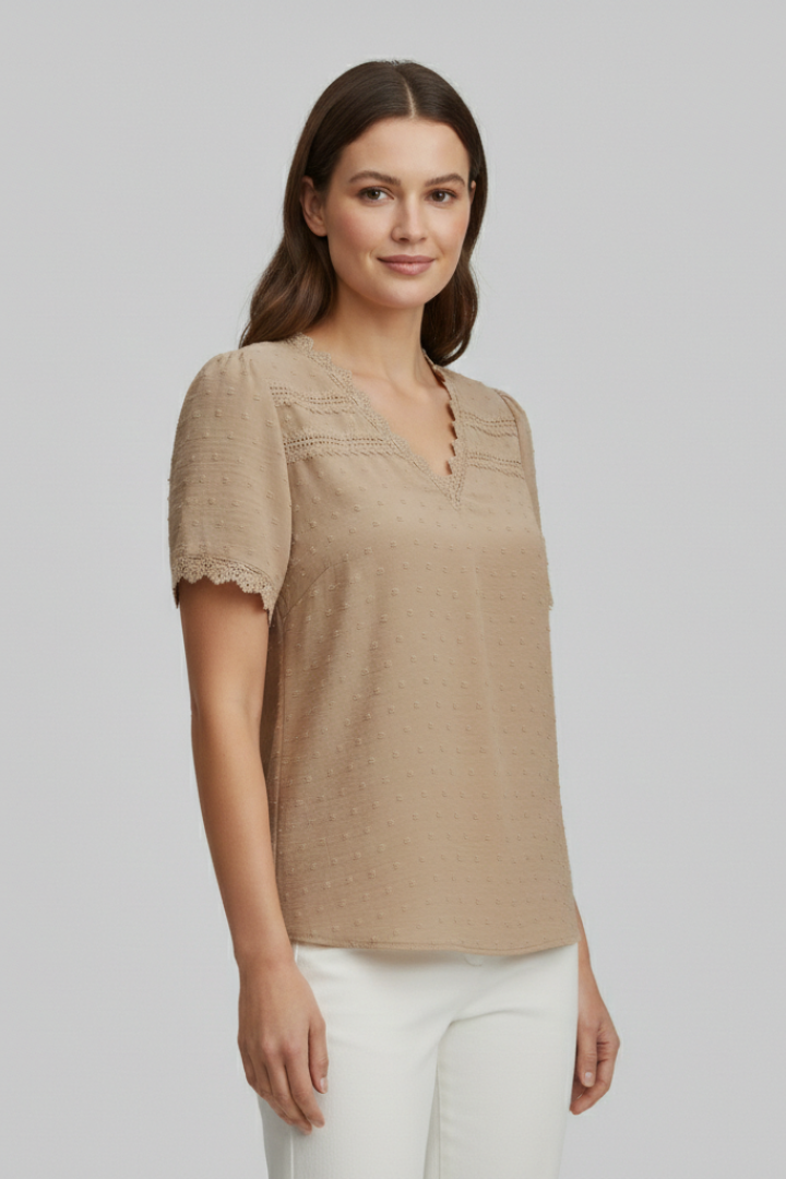 Women’s short sleeve blouse with V neckline, partial button fastening, and textured semi-sheer surface, suitable for office wear and everyday styling.