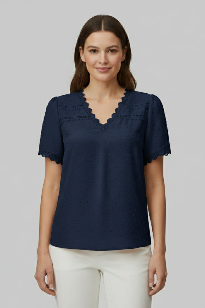 Women’s short sleeve blouse with V neckline, partial button fastening, and textured semi-sheer surface, suitable for office wear and everyday styling.