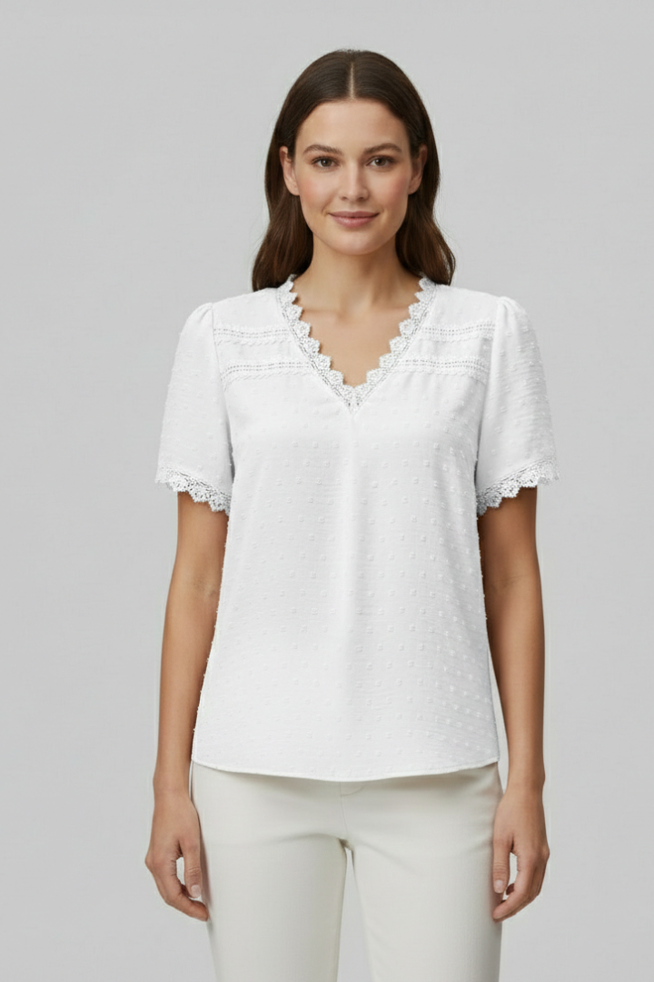 Women’s short sleeve blouse with V neckline, partial button fastening, and textured semi-sheer surface, suitable for office wear and everyday styling.