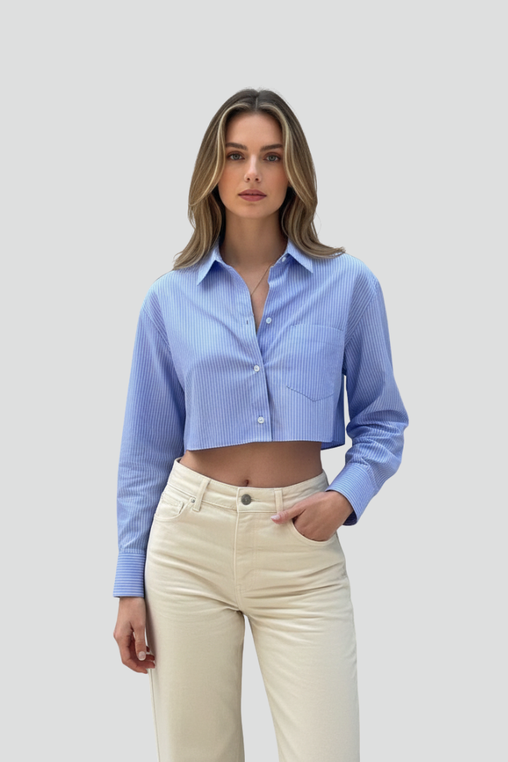 Women’s cropped shirt with pointed collar, button closure, striped pattern, and long sleeves for modern casual styling.