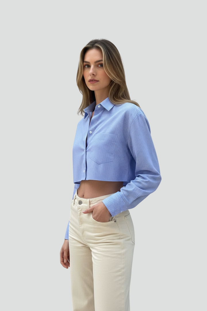 Women’s cropped shirt with pointed collar, button closure, striped pattern, and long sleeves for modern casual styling.