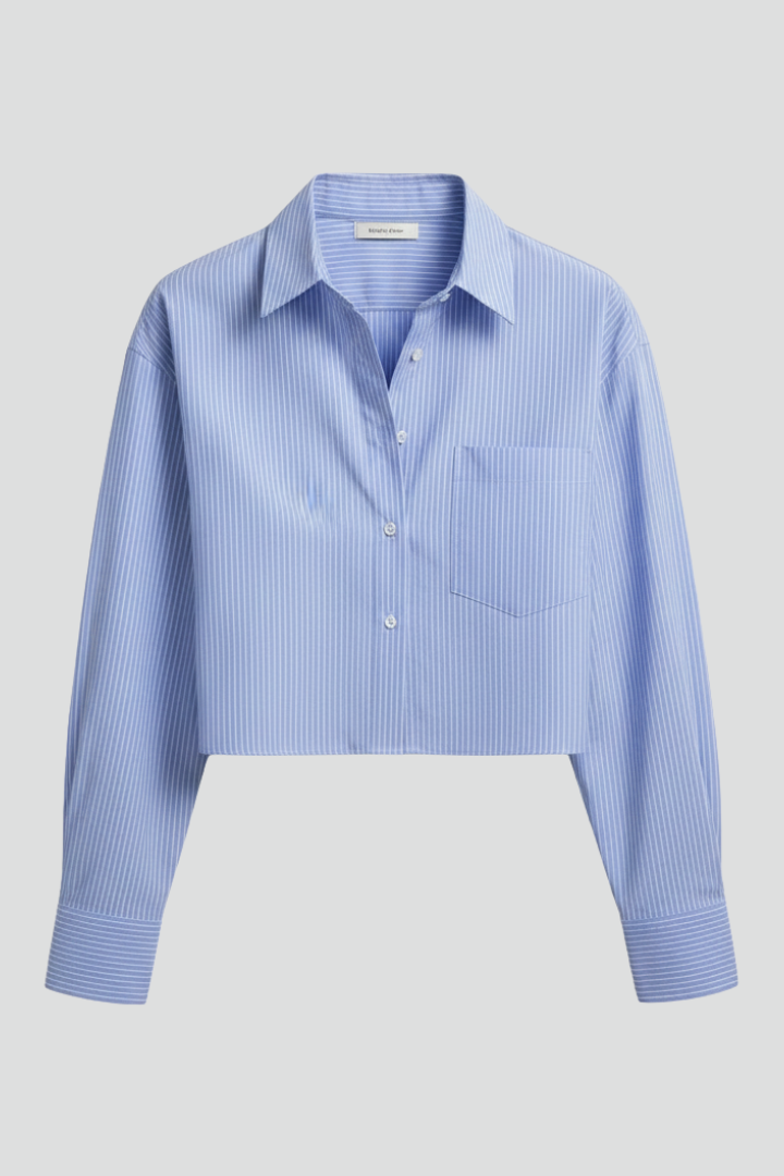Women’s cropped shirt with pointed collar, button closure, striped pattern, and long sleeves for modern casual styling.