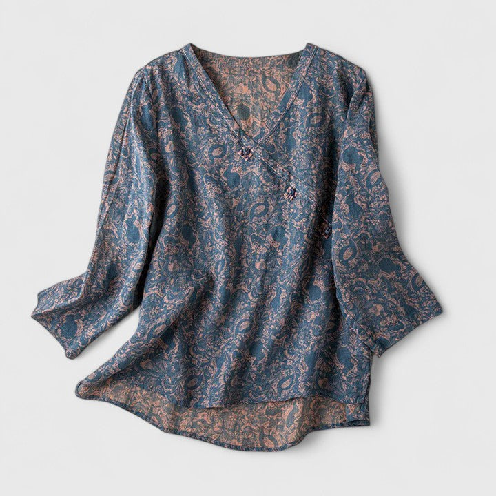 Women’s embroidered blouse with roll-tab sleeves and a relaxed fit, suitable for office outfits, casual wear, and everyday styling.