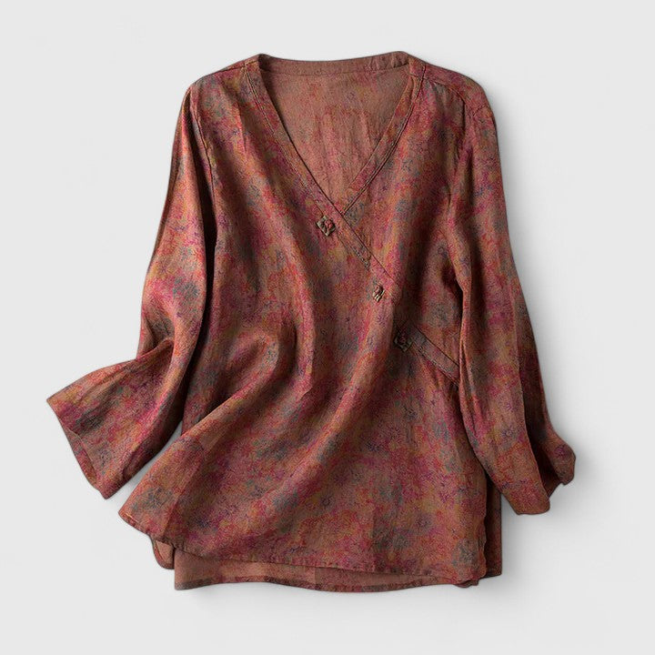 Women’s embroidered blouse with roll-tab sleeves and a relaxed fit, suitable for office outfits, casual wear, and everyday styling.