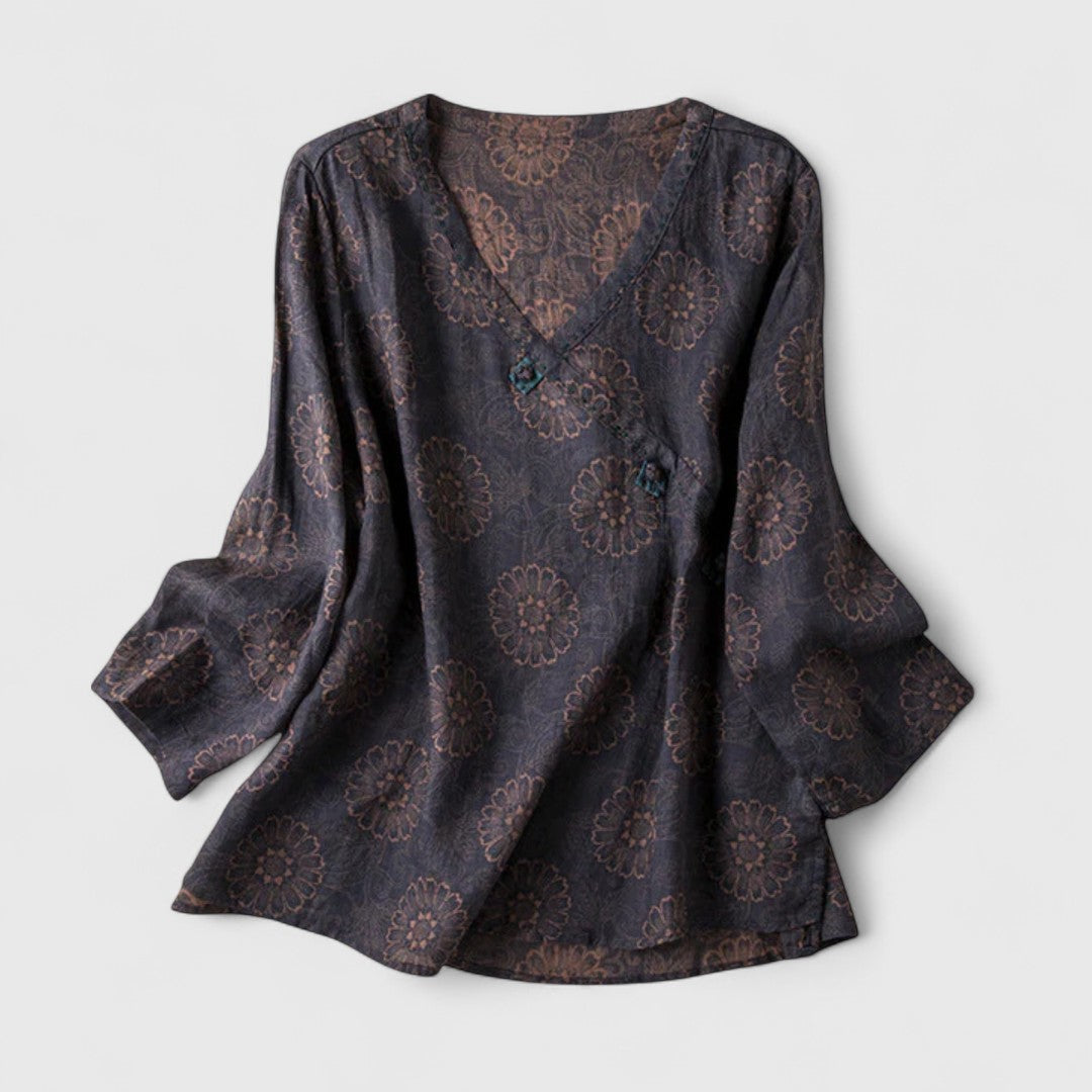 Women’s embroidered blouse with roll-tab sleeves and a relaxed fit, suitable for office outfits, casual wear, and everyday styling.