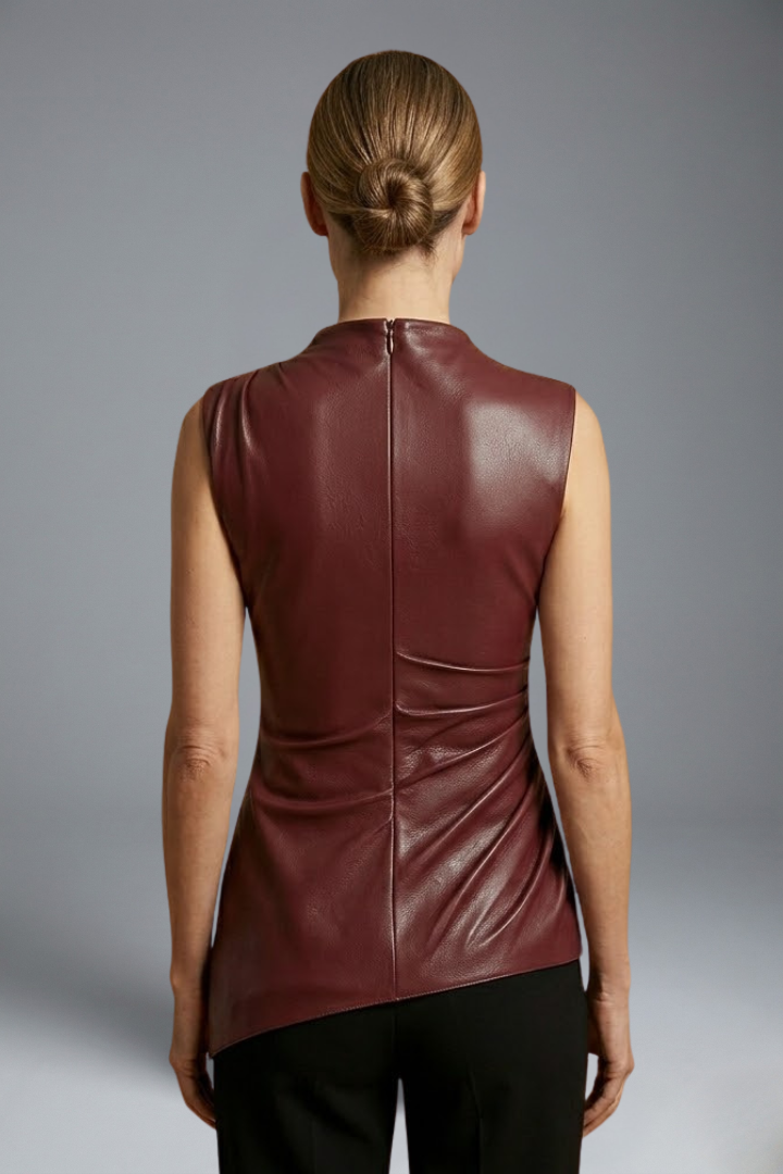 Women’s fitted top with structured neckline, sleeveless cut, smooth surface finish, and contoured waist for modern everyday styling.