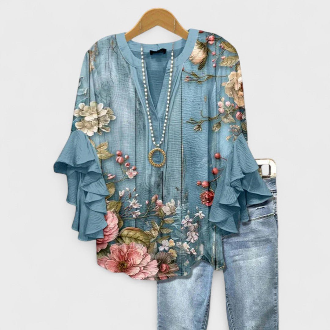 Women’s floral blouse with ruffle sleeves, V-neckline, and relaxed fit, suitable for office wear, casual outings, and everyday styling.