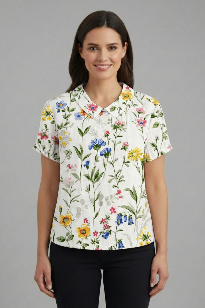Women’s short sleeve blouse with collared neckline and floral print, featuring a relaxed fit and textured surface for everyday and office wear.