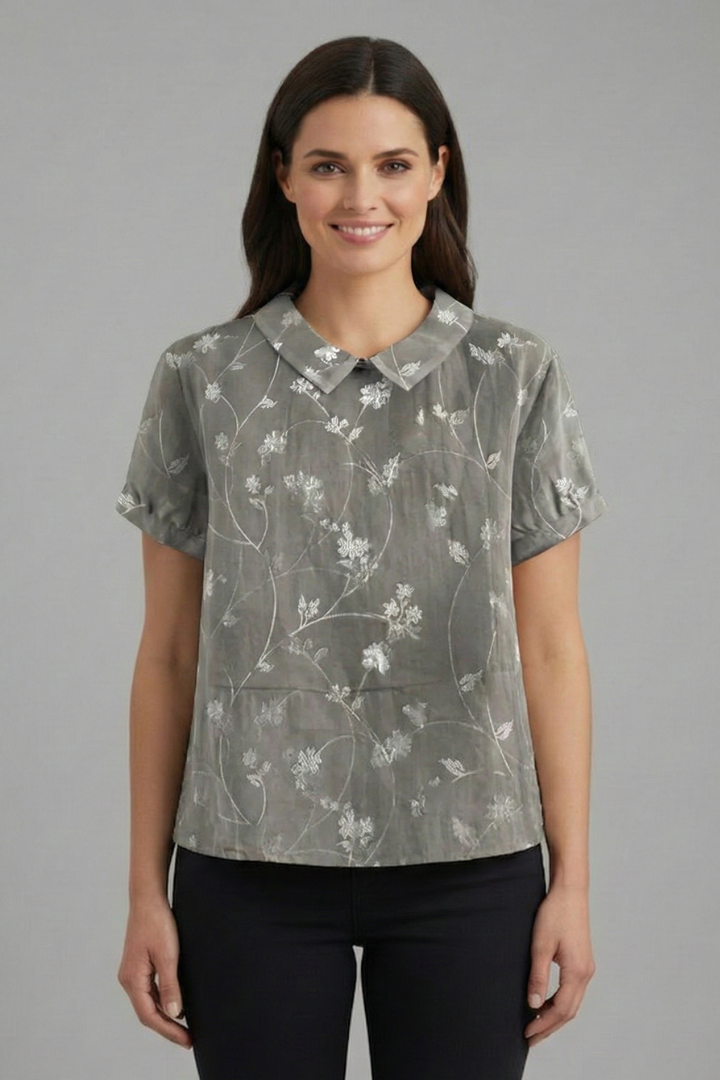 Women’s short sleeve blouse with collared neckline and floral print, featuring a relaxed fit and textured surface for everyday and office wear.
