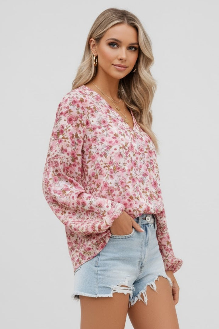 Women’s floral blouse with V-neckline and relaxed fit, featuring long sleeves and all-over print for casual and work outfits