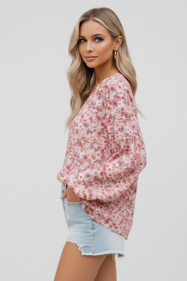 Women’s floral blouse with V-neckline and relaxed fit, featuring long sleeves and all-over print for casual and work outfits