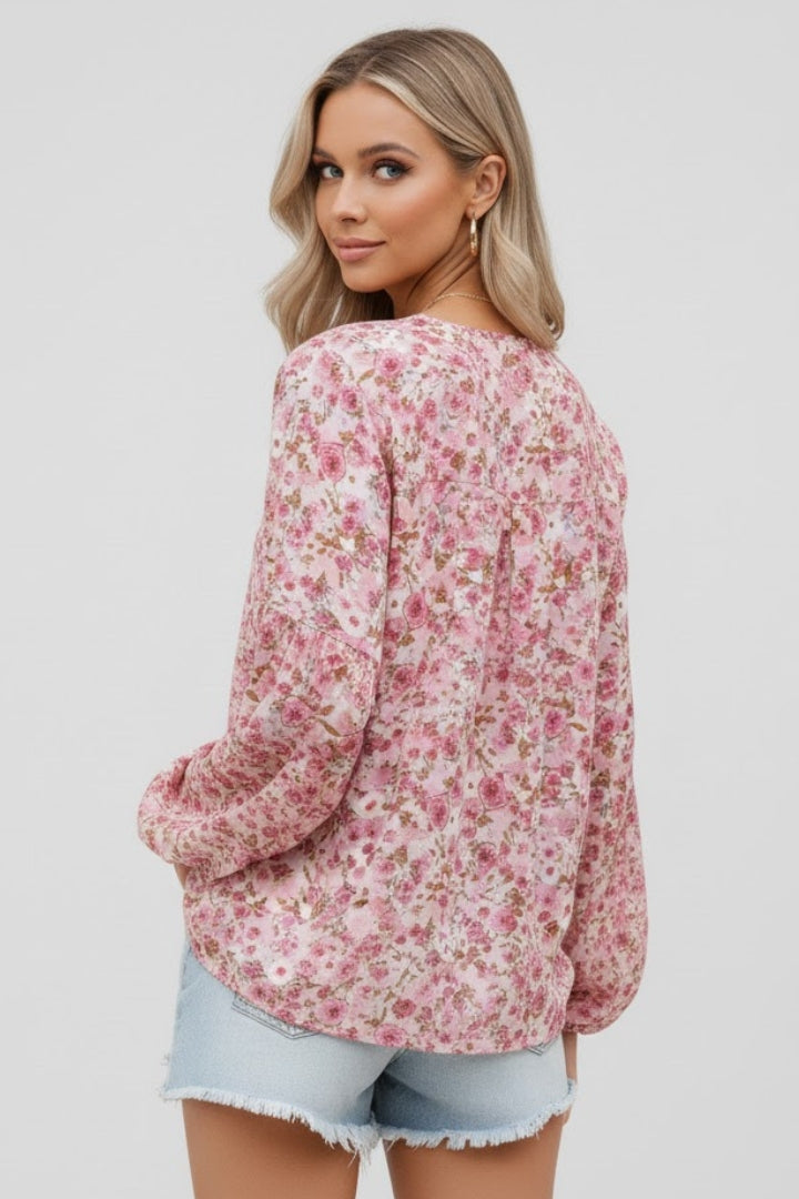 Women’s floral blouse with V-neckline and relaxed fit, featuring long sleeves and all-over print for casual and work outfits