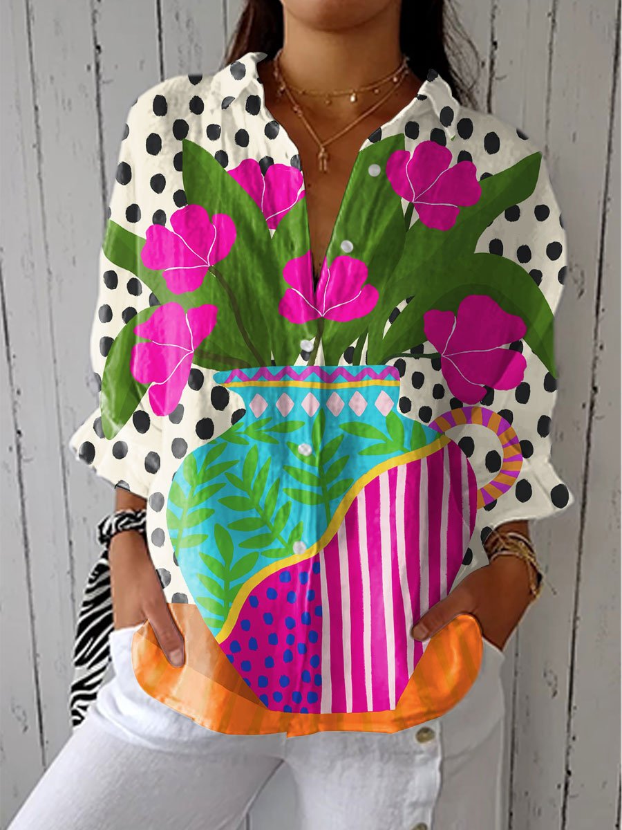 Women’s floral blouse with V-neckline, button-front closure, and artistic floral vase print, suitable for casual outings and summer styling.