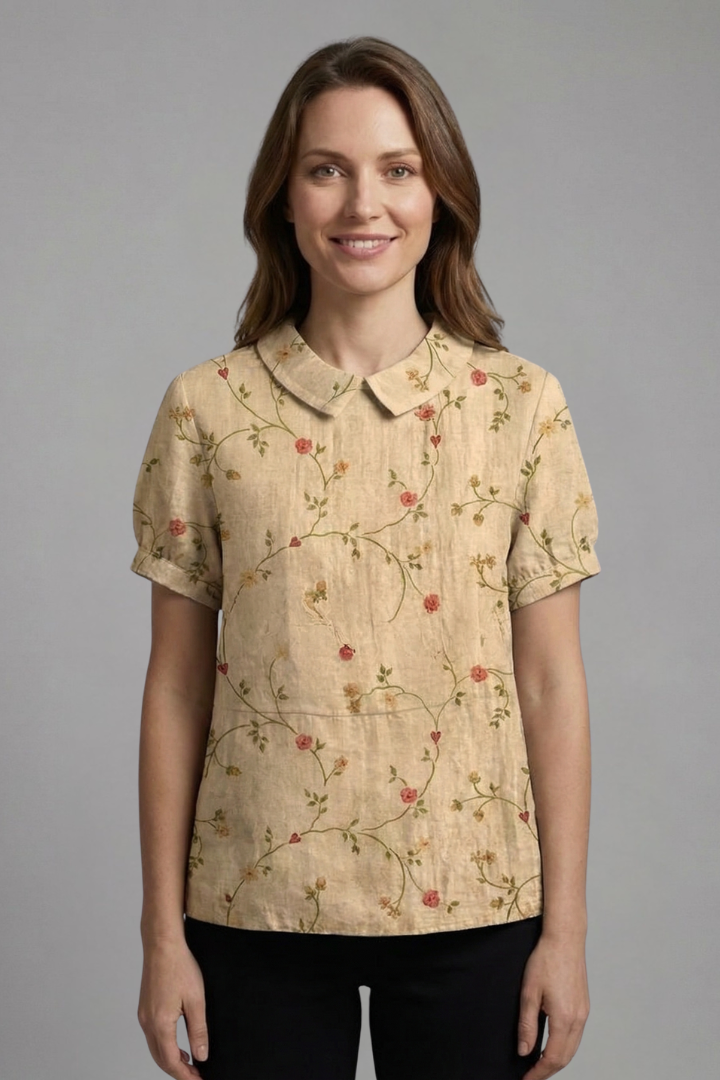Women’s floral blouse with notch neckline and short sleeves, ideal for casual outfits and smart everyday styling.