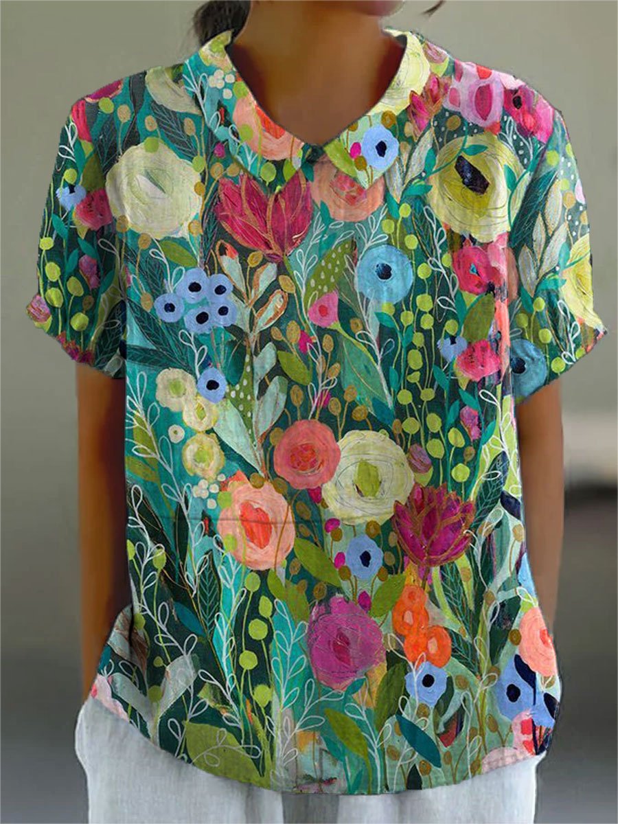Women’s floral blouse with watercolor print, V-neckline, short sleeves, and relaxed fit, suitable for casual outings, vacations, and summer styling.