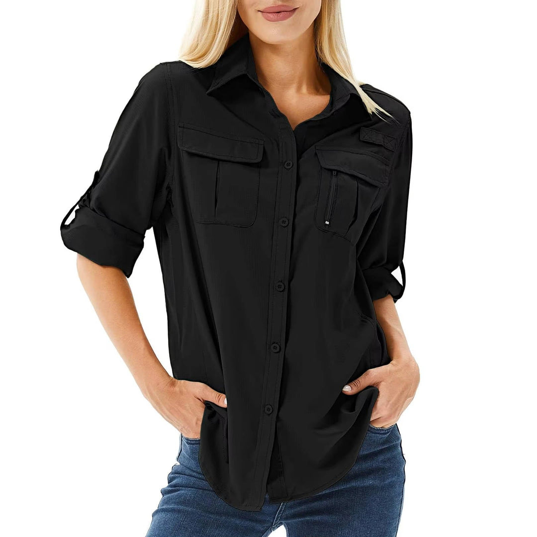 Women’s hiking shirt with roll-up sleeves, chest pockets, UPF 50 protection, and relaxed fit, suitable for hiking, camping, and outdoor activities.