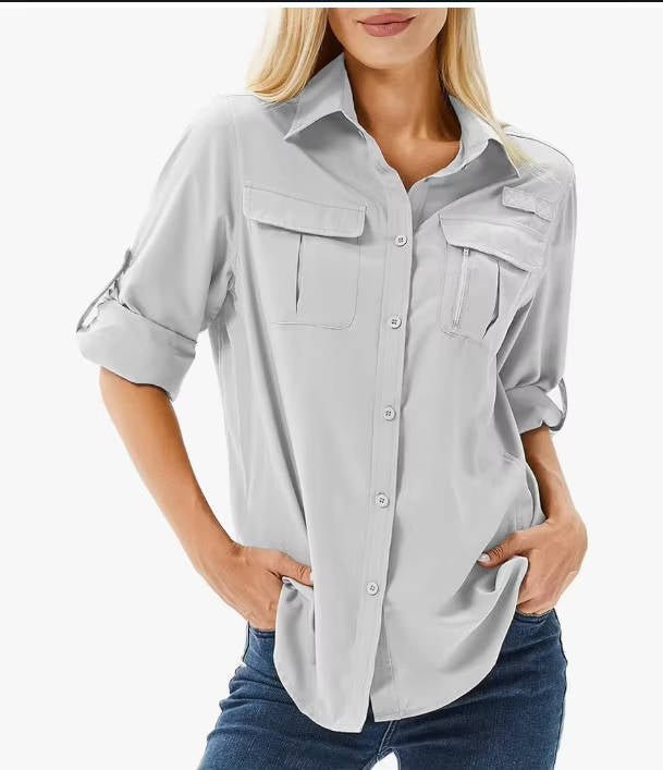 Women’s hiking shirt with roll-up sleeves, chest pockets, UPF 50 protection, and relaxed fit, suitable for hiking, camping, and outdoor activities.