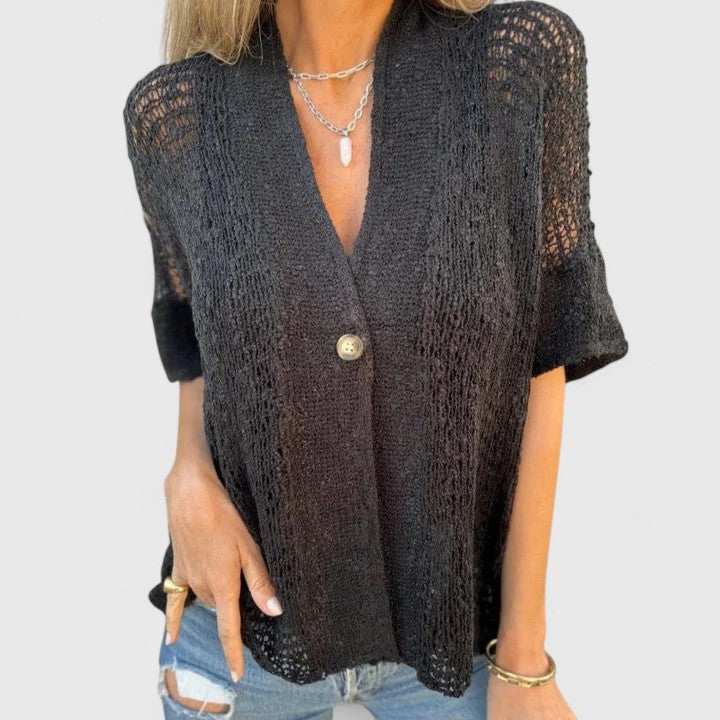 Women’s knit shirt with an open stitch design, single-button closure, and relaxed fit, ideal for warm-weather wear and casual layering.