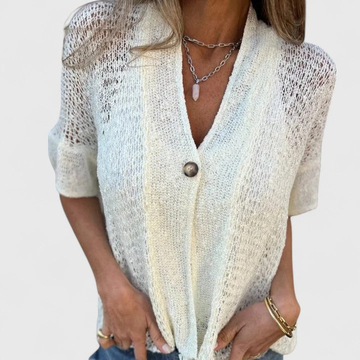 Women’s knit shirt with an open stitch design, single-button closure, and relaxed fit, ideal for warm-weather wear and casual layering.