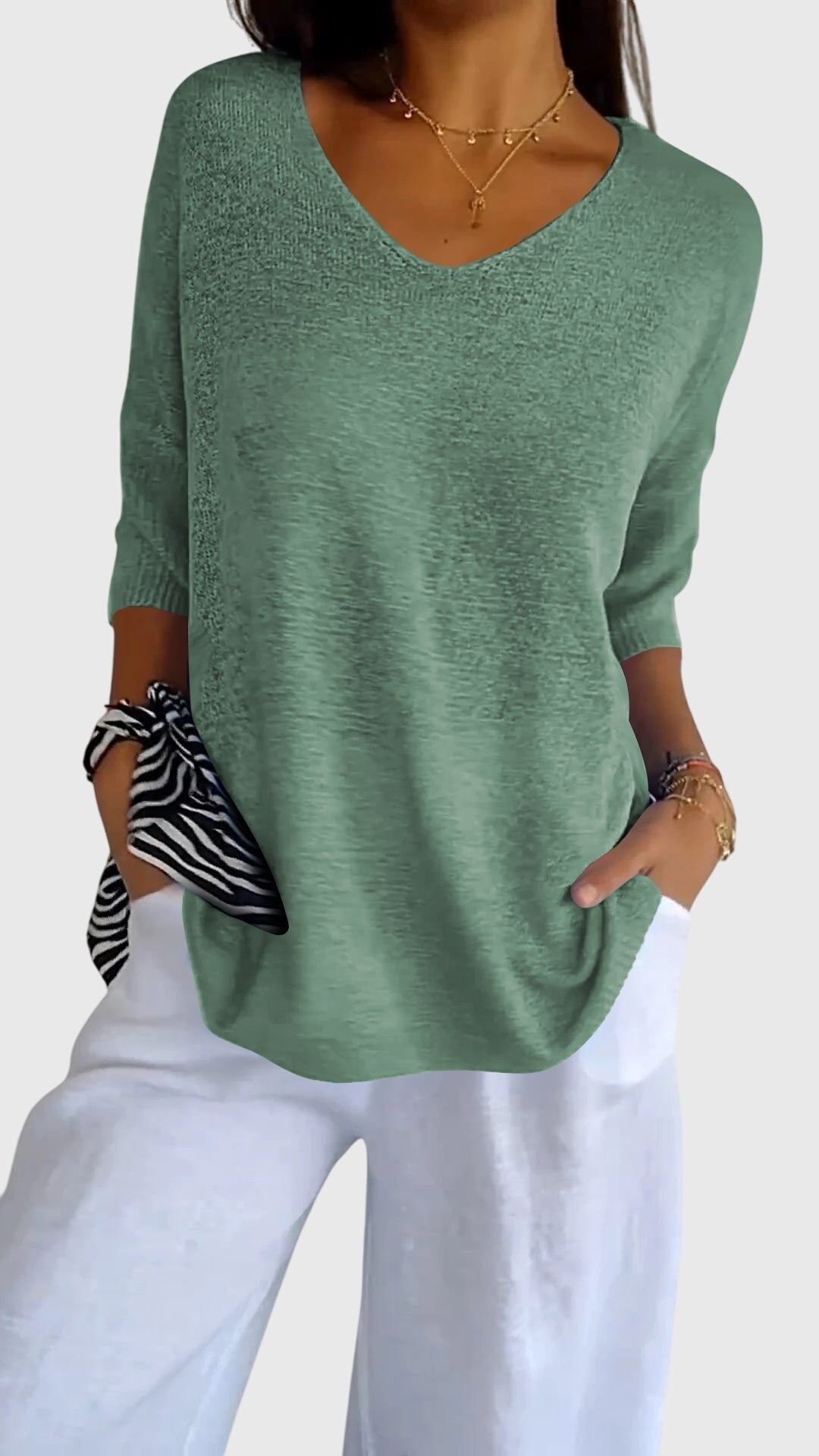 Women’s knit top with V-neckline and soft fit, ideal for layering, casual outfits, office wear, and everyday styling.