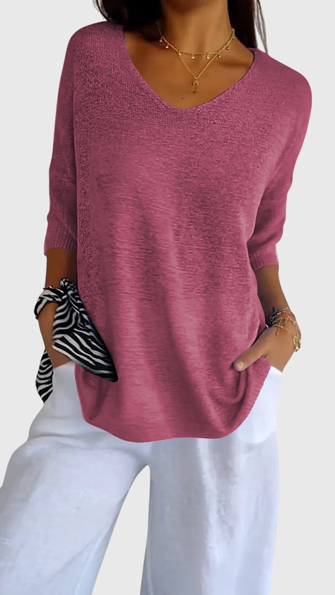 Women’s knit top with V-neckline and soft fit, ideal for layering, casual outfits, office wear, and everyday styling.
