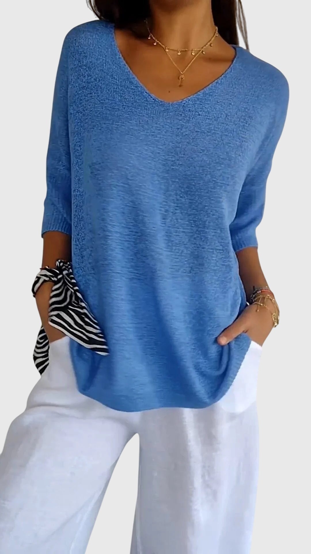 Women’s knit top with V-neckline and soft fit, ideal for layering, casual outfits, office wear, and everyday styling.