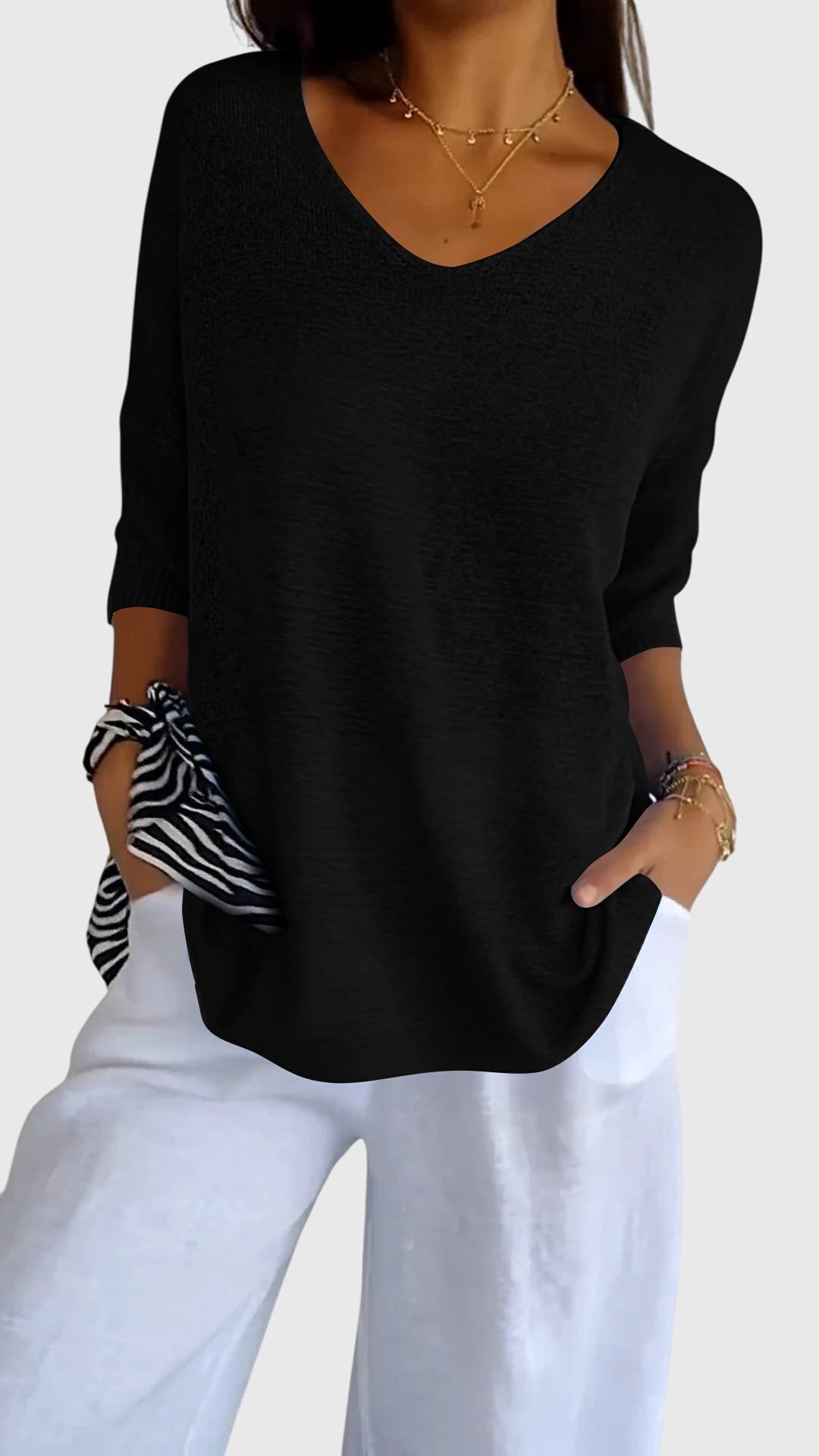 Women’s knit top with V-neckline and soft fit, ideal for layering, casual outfits, office wear, and everyday styling.